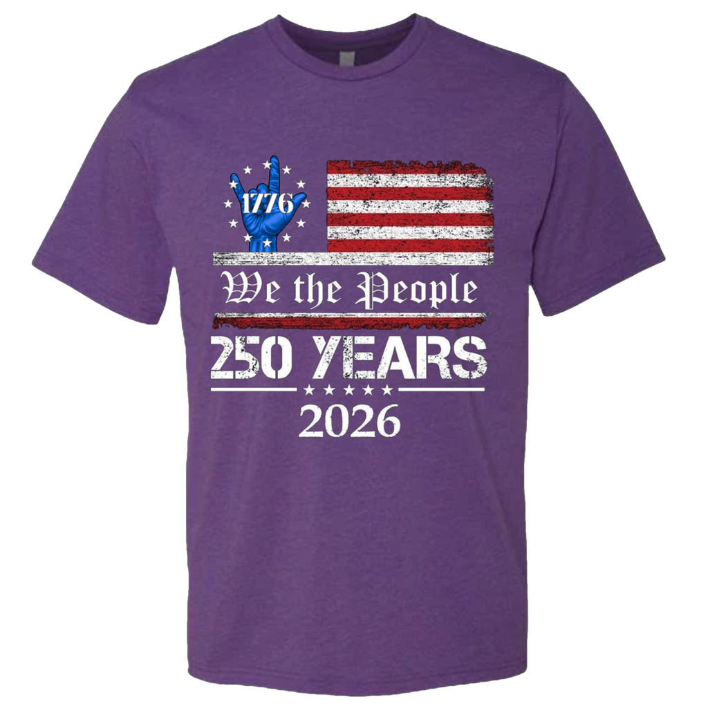 A Purple Rush t-shirt with a patriotic design.  An American flag with red and white horizontal stripes, with a blue ASL "I Love You" signing hand with a circle of stars.  The text design says "We The People" and "250 Years 2026" in white.